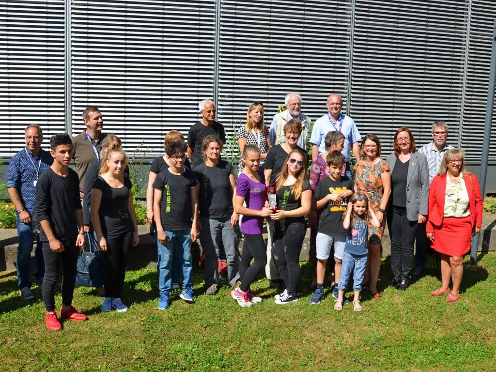 Bewunderten den Green City Trail am Hörsaalgebäude in der Biegenstraße: Staatsministerin Priska Hinz (4. v. r.), Stadträtin Dr. Kerstin Weinbach (3. v. r.), Peter Schmittdiel vom städtischen Fachdienst Zentrale Jugendhilfeförderdienste (2. v. r.), Stadtverordnetenvorsteherin Marianne Wölk (r.), Landrätin Kirsten Fründt (5. v. r.) und Vertreterinnen und Vertreter der Interessengemeinschaft Bildung für nachhaltige Entwicklung um Initiatorin Nicole Kapaun (vorne, 4. v. l.). Foto: Philipp Höhn / Stadt Marburg